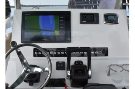 Slide: The Image of 2021 Key West 263FS boat dashboard with navigation screen and controls. - 29