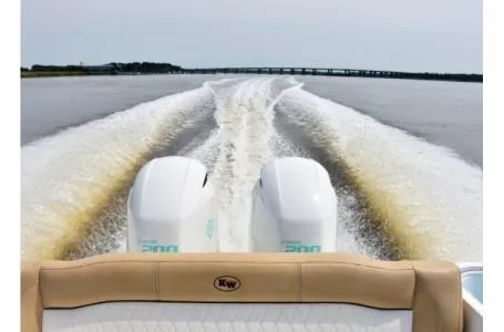 Slide: The Image of 2021 Key West 263FS boat cruising on open water, twin engines visible. - 3