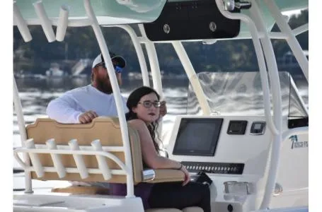 Slide: The Image of Two people on a 2021 Key West 263FS boat, enjoying a sunny day on the water. - 30