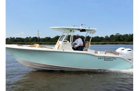 Slide: The Image of 2021 Key West 263FS boat cruising on a calm river. - 32