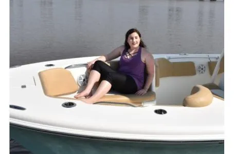Slide: The Image of Woman relaxing on a 2021 Key West 263FS boat in calm waters. - 34