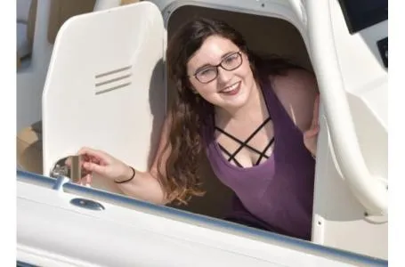 Slide: The Image of Woman smiling from cabin of 2021 Key West 263FS boat. - 35