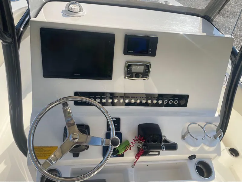 Slide: The Image of 2021 Key West 263FS boat dashboard with steering wheel and electronic controls. - 39