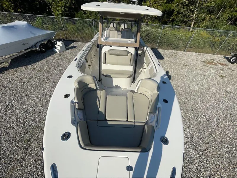 Slide: The Image of 2021 Key West 263FS boat with spacious seating and sleek design on gravel lot. - 40