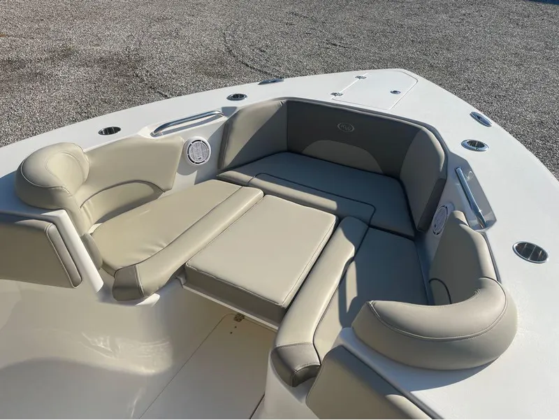 Slide: The Image of 2021 Key West 263FS boat interior with beige cushioned seating. - 43