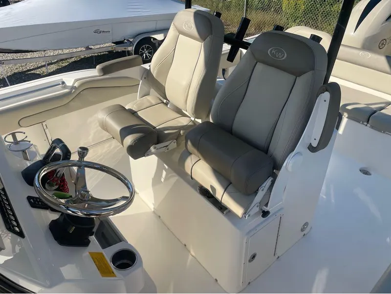 Slide: The Image of 2021 Key West 263FS boat interior with dual captain's chairs and steering wheel. - 44