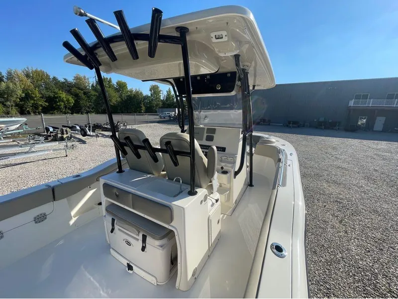 Slide: The Image of 2021 Key West 263FS boat interior with seating and storage, parked outdoors. - 47