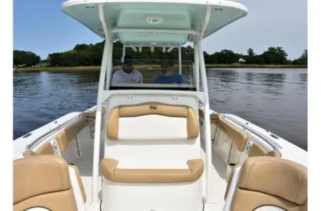 Slide: The Image of 2021 Key West 263FS boat on calm water with two people onboard. - 6