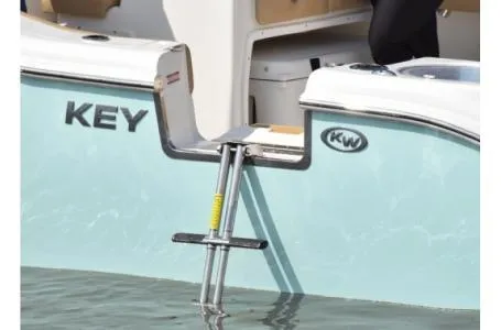 Slide: The Image of 2021 Key West 263FS boat with swim ladder in water. - 7