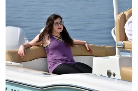 Slide: The Image of Woman relaxing on a 2021 Key West 263FS boat, enjoying a sunny day on the water. - 8