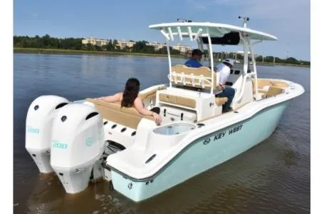 Slide: The Image of 2021 Key West 263FS boat on calm water with passengers. - 9