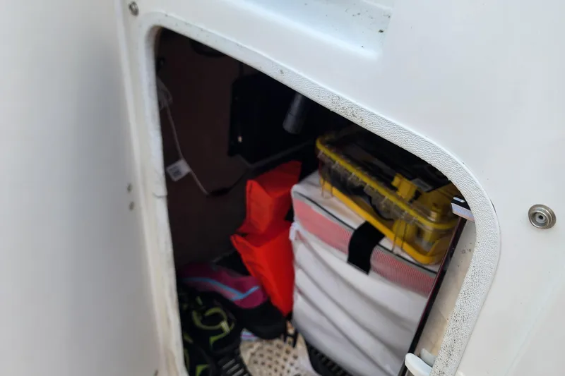 Slide: The Image of Storage compartment in 2015 Chaparral 224 Sunesta boat with gear and equipment. - 12