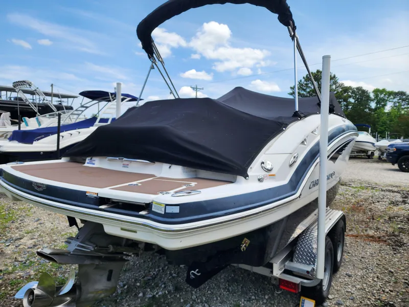 Slide: The Image of 2015 Chaparral 224 Sunesta boat on trailer with cover, parked outdoors. - 4
