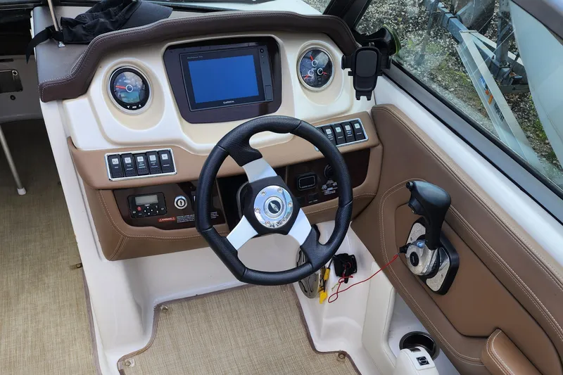 Slide: The Image of 2015 Chaparral 224 Sunesta boat dashboard with steering wheel and controls. - 7