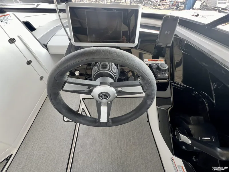Slide: The Image of 2025 Yamaha AR250 boat cockpit with steering wheel and control panel. - 2
