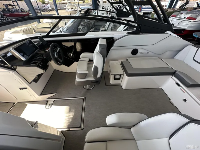 Slide: The Image of 2025 Yamaha Boats AR250 interior with modern seating and sleek dashboard design. - 6