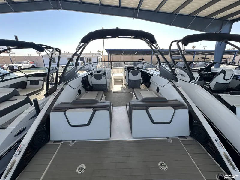 Slide: The Image of 2025 Yamaha Boats AR250 interior with sleek seating and modern design under a canopy. - 8