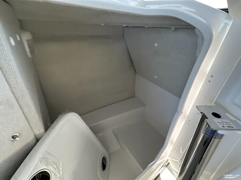Slide: The Image of Interior storage compartment of 2025 Yamaha AR250 boat, featuring sleek white design. - 9