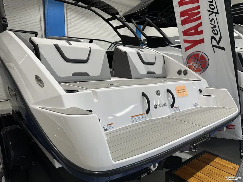 Slide: The Image of 2025 Yamaha Boats AR220, sleek design, rear view, showcased indoors. - 14