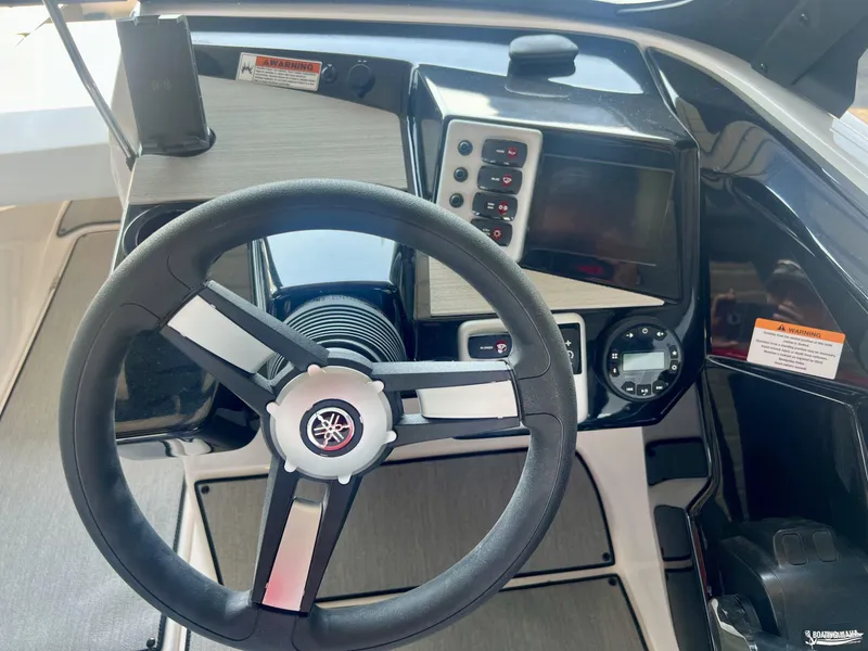 Slide: The Image of 2025 Yamaha AR220 boat dashboard with steering wheel and control panel. - 3