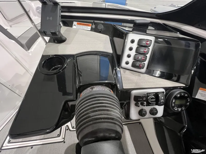 Slide: The Image of 2025 Yamaha AR220 boat dashboard with controls and cup holder. - 6