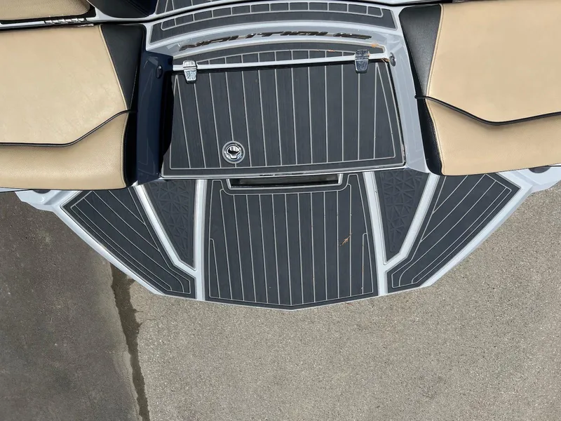Slide: The Image of 2022 Nautique Super Air Nautique G23 Paragon boat deck with tan and black seating. - 11