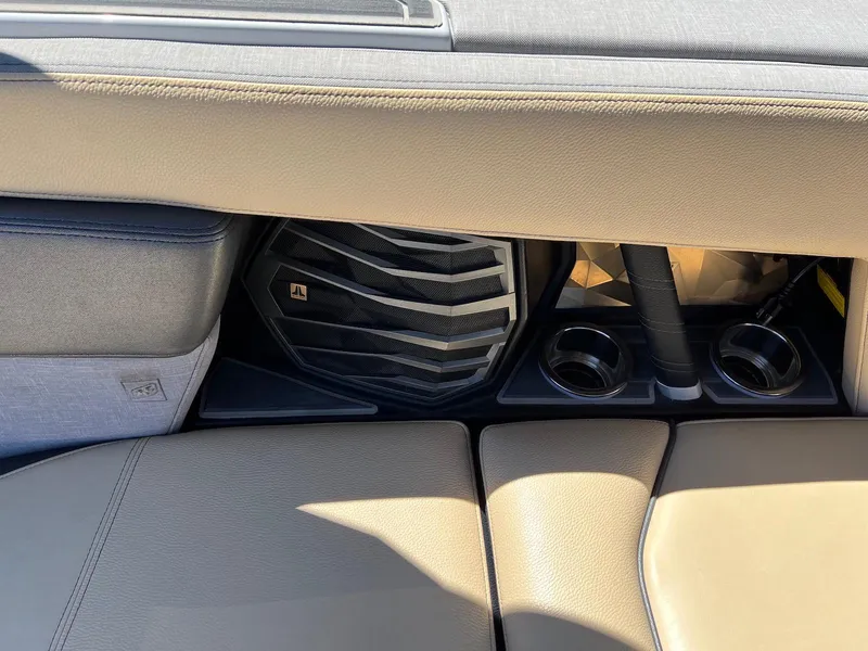 Slide: The Image of 2022 Nautique Super Air Nautique G23 Paragon interior with speaker and cup holders. - 13