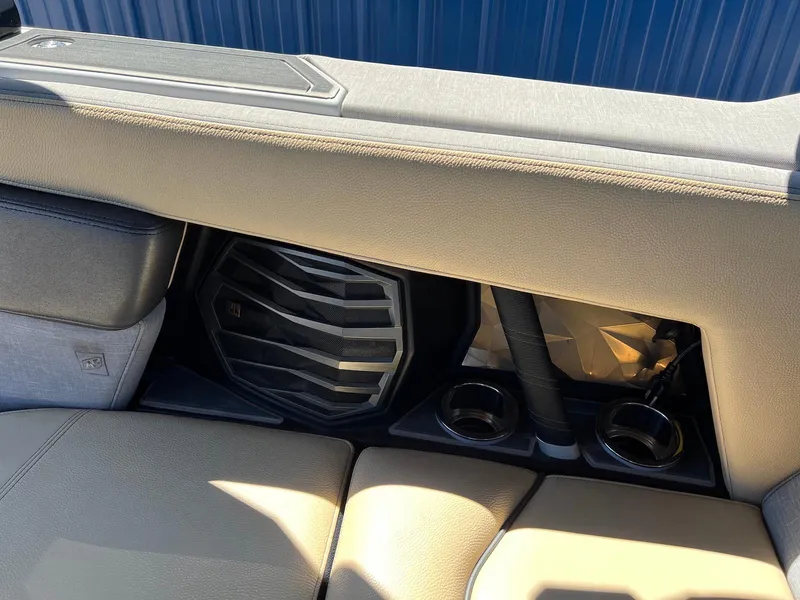 Slide: The Image of 2022 Nautique Super Air Nautique G23 Paragon interior with speaker and cup holders. - 22