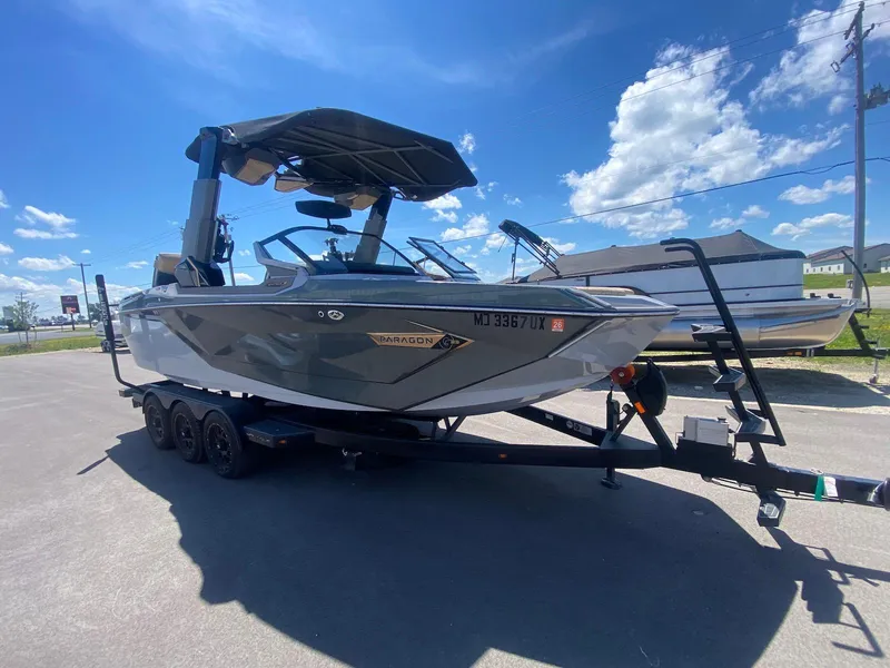 Slide: The Image of 2022 Nautique Super Air Nautique G23 Paragon boat on trailer under clear blue sky. - 4
