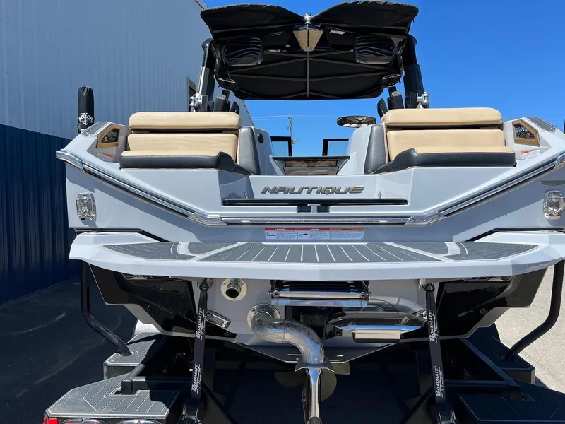 Slide: The Image of 2022 Nautique Super Air Nautique G23 Paragon boat, rear view with seating and sleek design. - 5