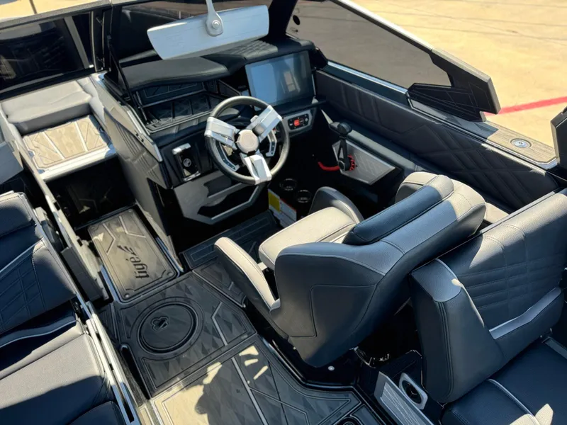 Slide: The Image of Interior of 2024 Tigé 23ZX Ultre' boat, featuring sleek black seating and modern dashboard. - 11