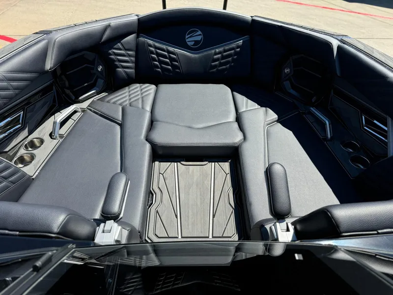 Slide: The Image of 2024 Tigé 23ZX Ultre' boat interior with luxurious black seating and cup holders. - 15