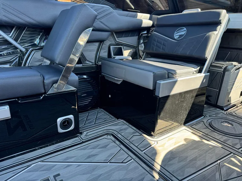 Slide: The Image of 2024 Tigé 23ZX Ultre' interior seating with sleek black and gray design. - 19