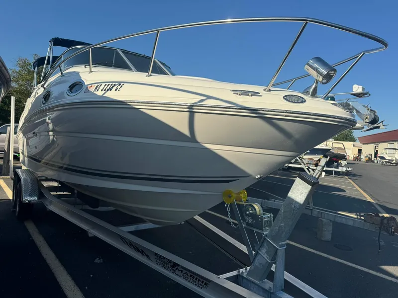 Slide: The Image of 2009 Sea Ray 240 Sundancer boat on trailer in parking lot. - 1