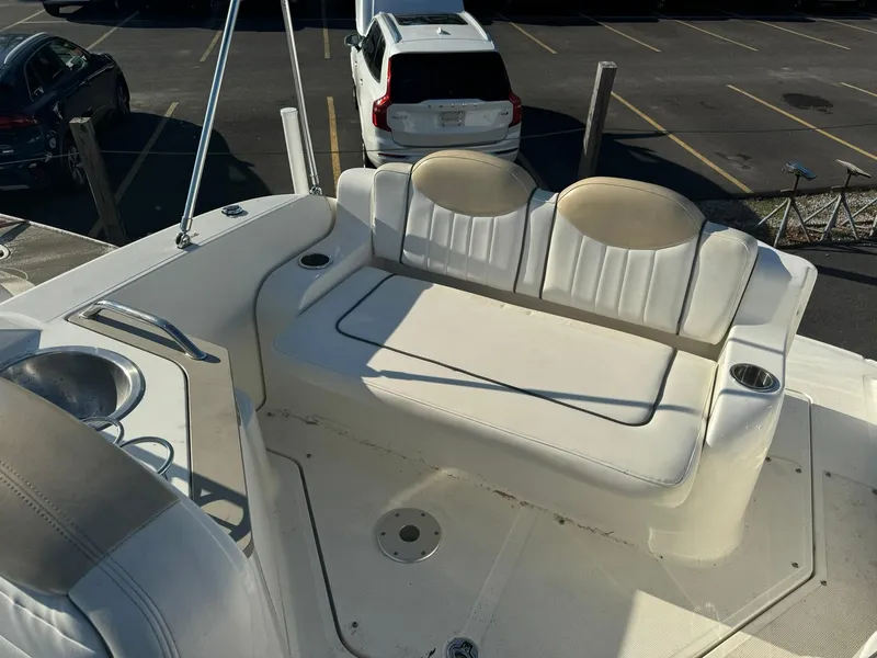 Slide: The Image of 2009 Sea Ray 240 Sundancer boat interior with white seating and cup holders. - 10