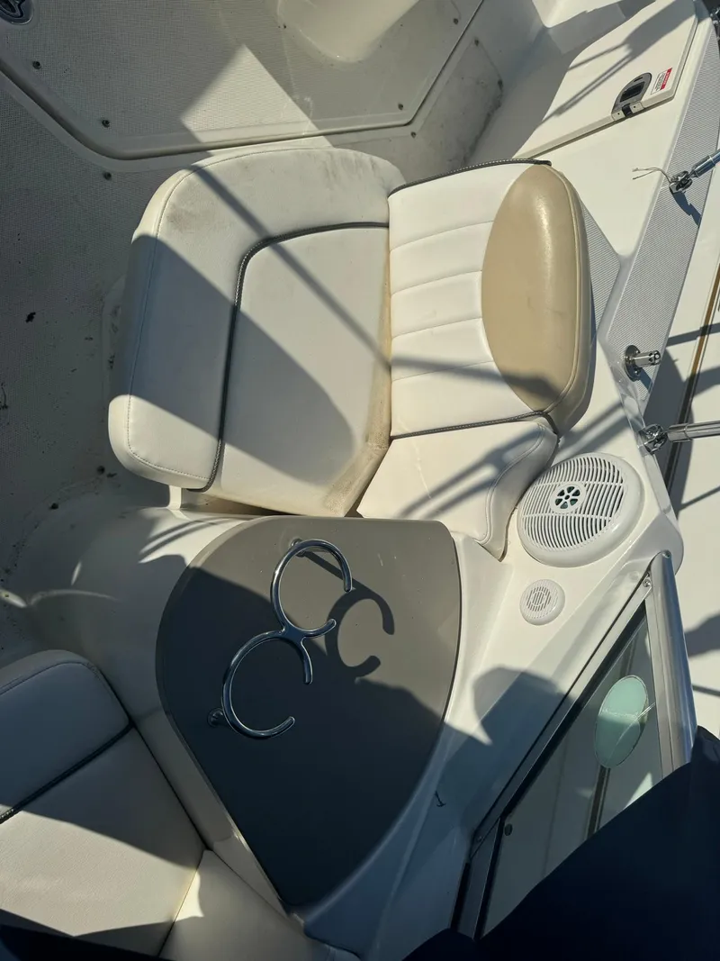 Slide: The Image of 2009 Sea Ray 240 Sundancer boat interior with seating and cup holders. - 11