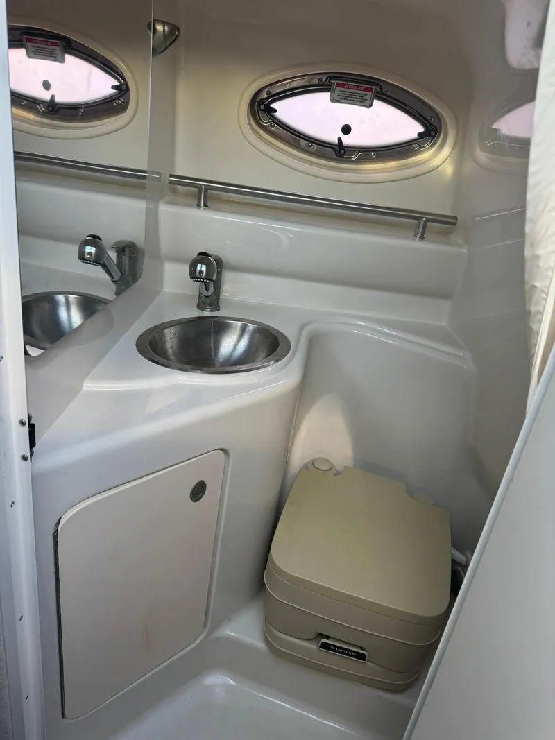 Slide: The Image of 2009 Sea Ray 240 Sundancer bathroom with sink and portable toilet. - 14