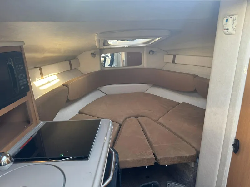 Slide: The Image of Interior of 2009 Sea Ray 240 Sundancer boat with cozy seating and modern amenities. - 16