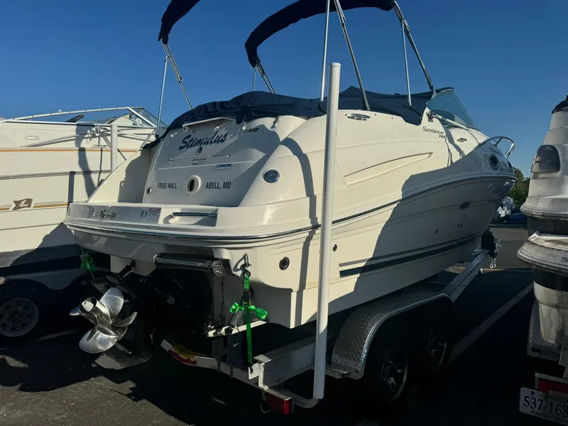 Slide: The Image of 2009 Sea Ray 240 Sundancer boat on trailer, rear view, parked outdoors. - 2