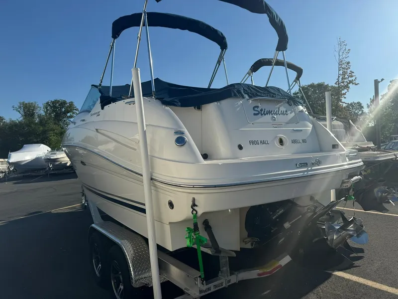 Slide: The Image of 2009 Sea Ray 240 Sundancer boat on trailer, outdoor setting. - 4