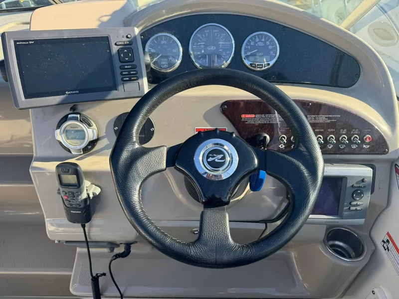 Slide: The Image of Dashboard of 2009 Sea Ray 240 Sundancer with steering wheel and navigation instruments. - 6