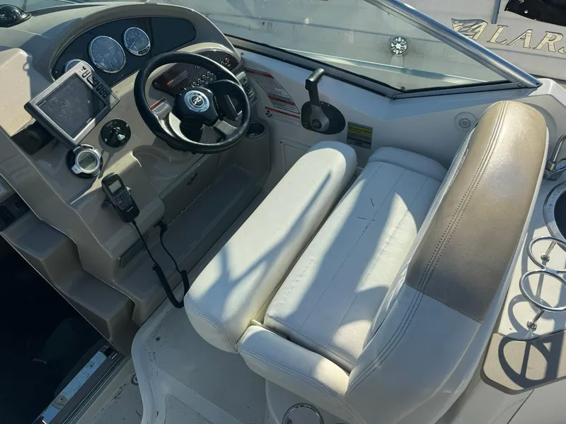 Slide: The Image of 2009 Sea Ray 240 Sundancer boat cockpit with steering wheel and seating. - 7