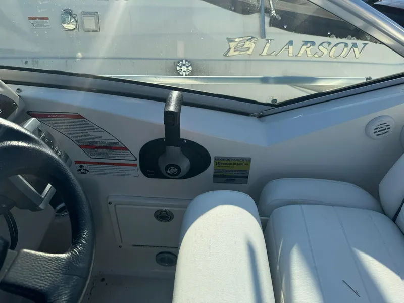 Slide: The Image of Interior view of 2009 Sea Ray 240 Sundancer boat cockpit with steering wheel and controls. - 8