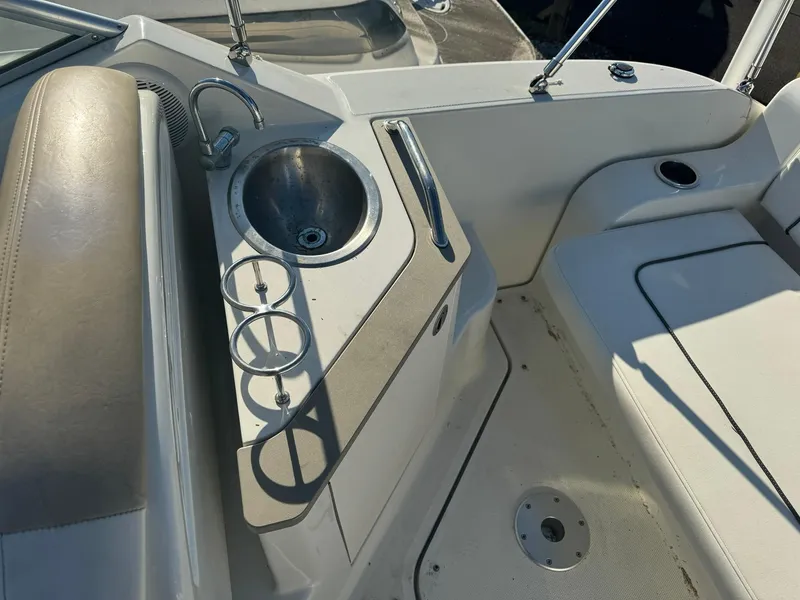Slide: The Image of 2009 Sea Ray 240 Sundancer boat interior with sink and seating area. - 9