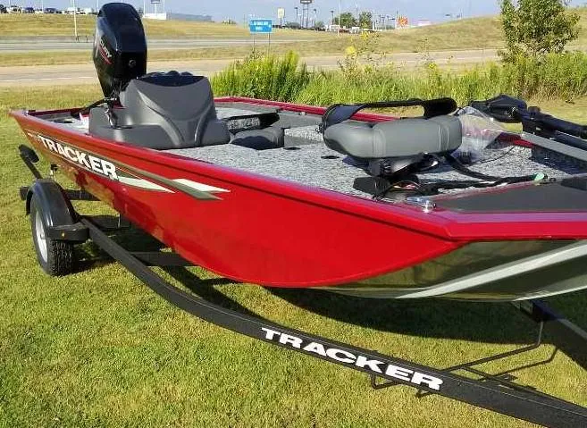 Slide: The Image of 2025 Tracker Pro 170 boat in vibrant red on a grassy area. - 2