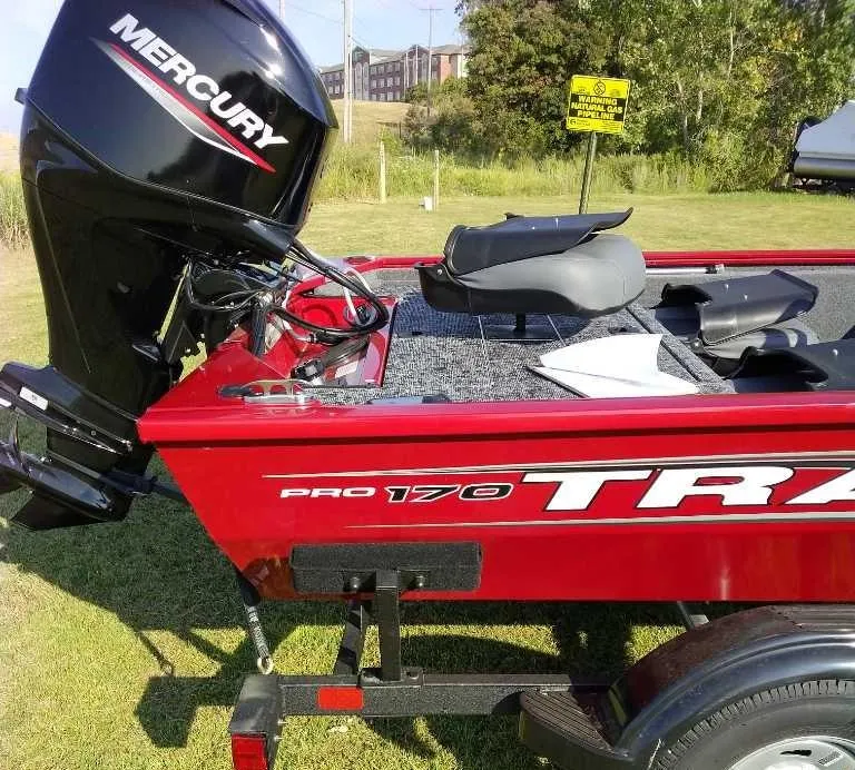 Slide: The Image of 2025 Tracker Pro 170 boat with Mercury engine on grassy area. - 3
