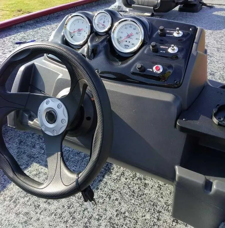 Slide: The Image of 2025 Tracker Pro 170 boat dashboard with steering wheel and gauges. - 6