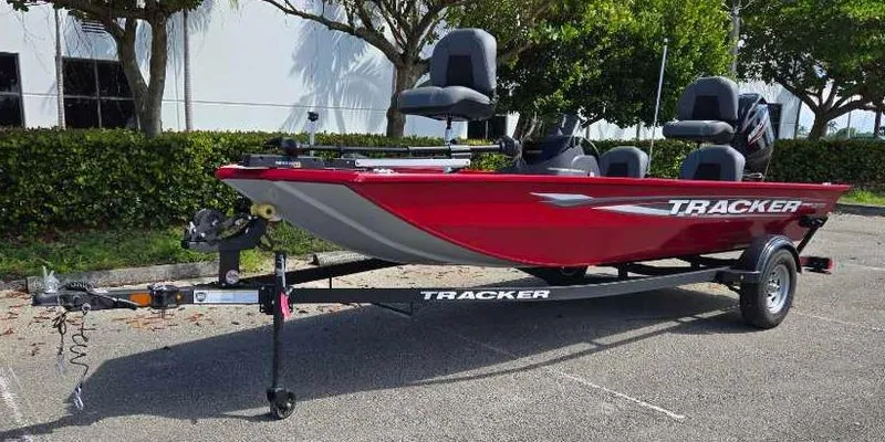 Slide: The Image of 2025 Tracker Pro 170 boat on trailer, red exterior, parked outdoors. - 2