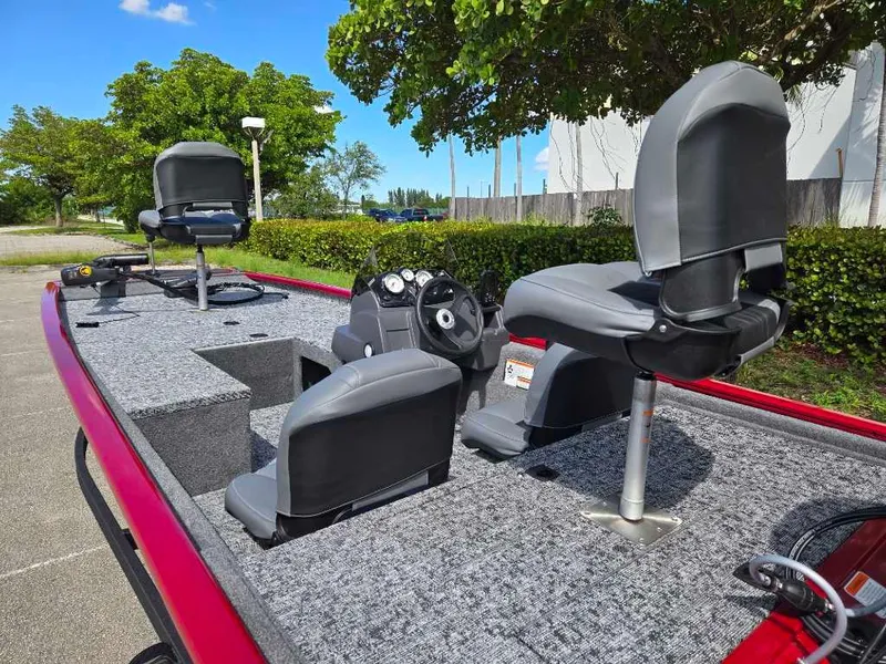 Slide: The Image of 2025 Tracker Pro 170 boat with gray seating and red trim, parked outdoors. - 5