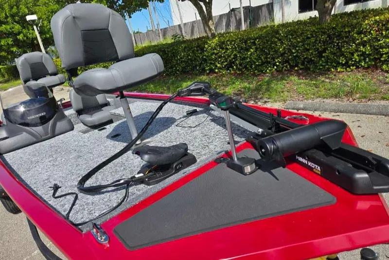 Slide: The Image of 2025 Tracker Pro 170 boat with seating and trolling motor, parked outdoors. - 6